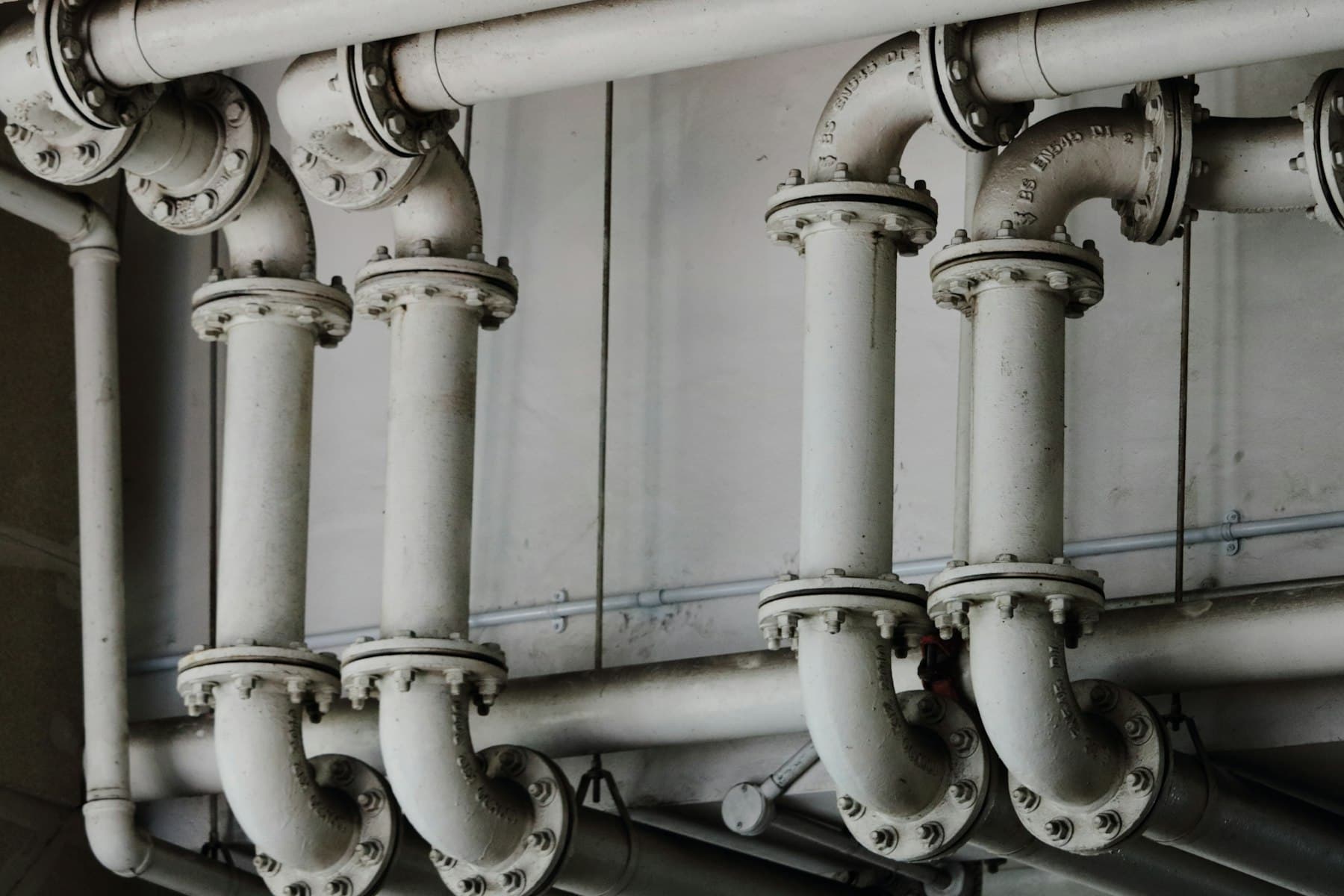 Grayscale photograph of industrial metal pipes
